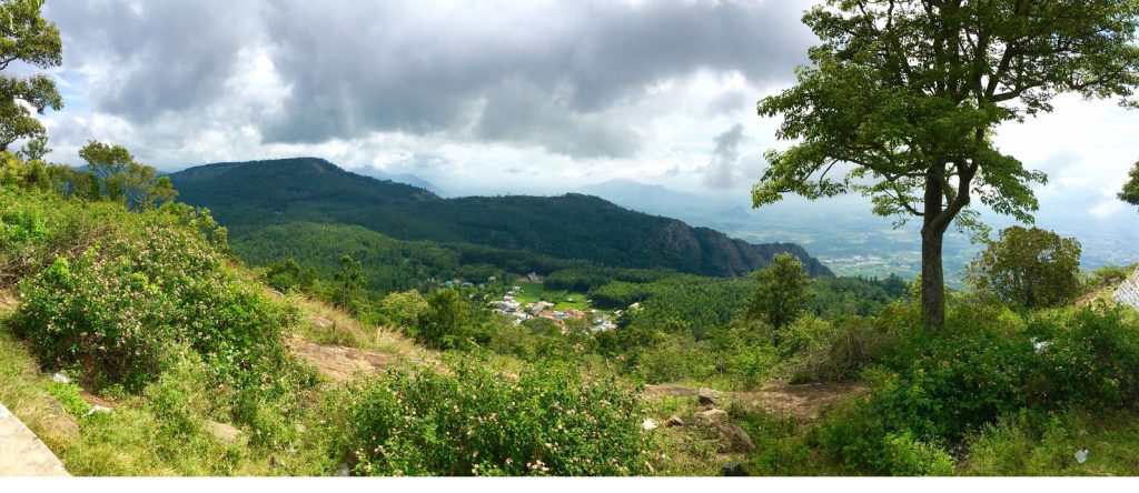 Panoramic view from Yercaud Hill Top Viewpoint, showcasing mist-covered valleys, lush green hills, and serene landscapes