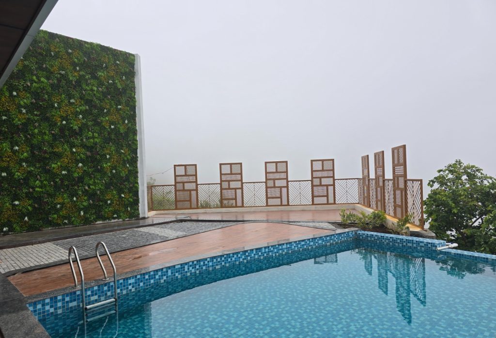 Infinity pool viewpoint at Mount Pico, Yercaud, offering panoramic views of misty hills and lush greenery